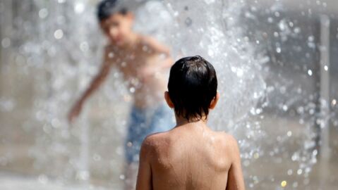 Ni&ntilde;os se ba&ntilde;an para soportar el calor
