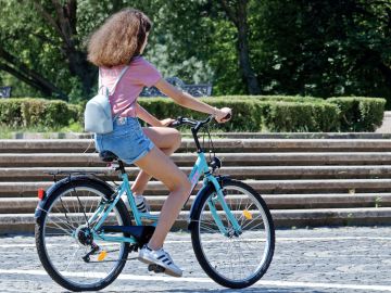 Una chica montando en bicicleta Una chica montando en bicicleta